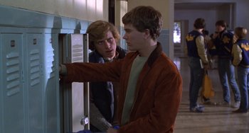 Movie still from “Ordinary People” (1980), directed by Robert Redford – Two young men standing in front of a door; Medium shot, Over the shoulder angle