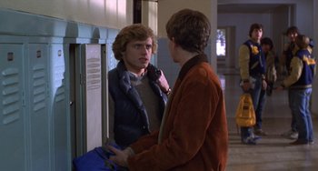 Movie still from “Ordinary People” (1980), directed by Robert Redford – A young man talking to another young man in front of a door; Medium shot, Over the shoulder angle