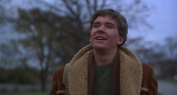 Movie still from “Ordinary People” (1980), directed by Robert Redford – A young man wearing a brown coat and a green shirt; Close Up shot, Low angle