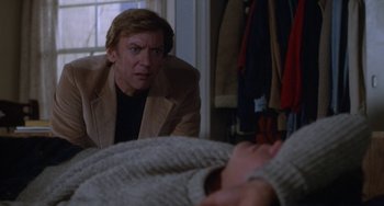 Movie still from “Ordinary People” (1980), directed by Robert Redford – A man looking at a woman in a bed; Medium shot, Over the shoulder angle
