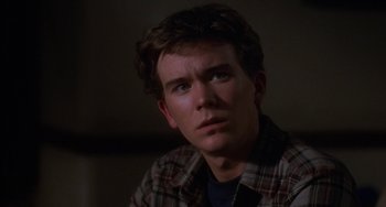 Movie still from “Ordinary People” (1980), directed by Robert Redford – A young man in a plaid shirt looking at the camera; Close Up shot, Over the shoulder angle
