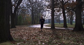 Movie still from “Ordinary People” (1980), directed by Robert Redford – A man walking in a park near some trees; Extreme Wide shot, High angle