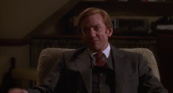 Movie still from “Ordinary People” (1980), directed by Robert Redford – A man in a suit and tie sitting on a couch; Close Up shot, High angle