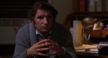 Movie still from “Ordinary People” (1980), directed by Robert Redford – A man sitting in front of a table with papers; Close Up shot, High angle