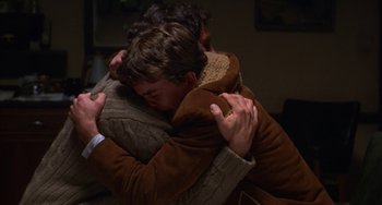 Movie still from “Ordinary People” (1980), directed by Robert Redford – Two people hugging each other in a room; Close Up shot, Over the shoulder angle