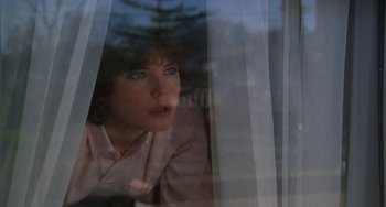 Movie still from “Ordinary People” (1980), directed by Robert Redford – A woman looking out of a window at a tree; Close Up shot, Low angle