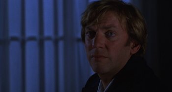 Movie still from “Ordinary People” (1980), directed by Robert Redford – A person wearing a suit and tie; Close Up shot, Over the shoulder angle