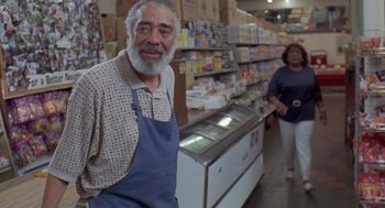 Movie still from “Original Gangstas” (1996), directed by Larry Cohen – An older man standing in front of a display case; Medium shot, Low angle