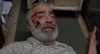 Movie still from “Original Gangstas” (1996), directed by Larry Cohen – An old man with a beard and a bloody face; Close Up shot, High angle