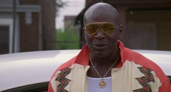 Movie still from “Original Gangstas” (1996), directed by Larry Cohen – A person wearing sunglasses and a jacket; Close Up shot, Low angle