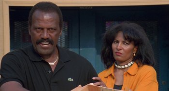 Movie still from “Original Gangstas” (1996), directed by Larry Cohen – A man and a woman standing next to each other; Close Up shot, Low angle