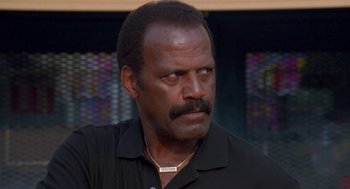 Movie still from “Original Gangstas” (1996), directed by Larry Cohen – A person wearing a black shirt; Close Up shot, Low angle