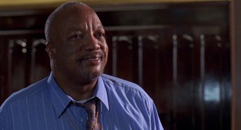 Movie still from “Original Gangstas” (1996), directed by Larry Cohen – An older man wearing a blue dress shirt and a tie; Close Up shot, Low angle