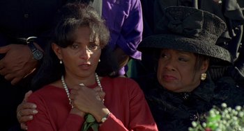 Movie still from “Original Gangstas” (1996), directed by Larry Cohen – A woman in a red dress and a woman in a black hat; Close Up shot, High angle