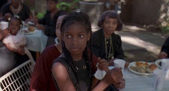 Movie still from “Original Gangstas” (1996), directed by Larry Cohen – A group of people sitting around a table; Close Up shot, Over the shoulder angle
