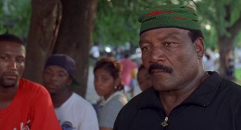Movie still from “Original Gangstas” (1996), directed by Larry Cohen – A group of people standing next to each other on the street; Close Up shot, Low angle