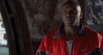 Movie still from “Original Gangstas” (1996), directed by Larry Cohen – A man in a red jacket is looking at the camera; Close Up shot, Low angle