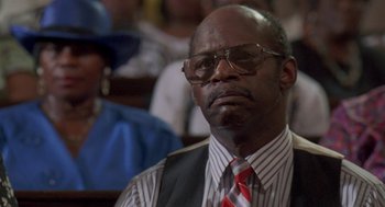 Movie still from “Original Gangstas” (1996), directed by Larry Cohen – An older man wearing a vest and a tie; Close Up shot, Low angle