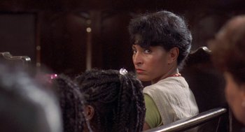 Movie still from “Original Gangstas” (1996), directed by Larry Cohen – A woman sitting next to another woman in front of a mirror; Close Up shot, Over the shoulder angle