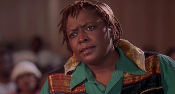 Movie still from “Original Gangstas” (1996), directed by Larry Cohen – A person wearing a green shirt; Close Up shot, Low angle