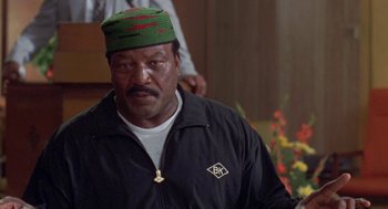 Movie still from “Original Gangstas” (1996), directed by Larry Cohen – A person wearing a hat; Close Up shot, Low angle