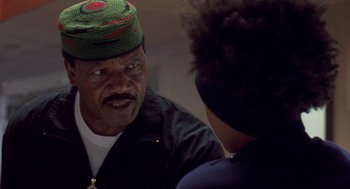 Movie still from “Original Gangstas” (1996), directed by Larry Cohen – An older man wearing a hat talking to a young man; Close Up shot, Low angle
