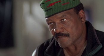 Movie still from “Original Gangstas” (1996), directed by Larry Cohen – A person wearing a hat; Close Up shot, Low angle