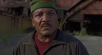 Movie still from “Original Gangstas” (1996), directed by Larry Cohen – A person wearing a hat; Close Up shot, Low angle