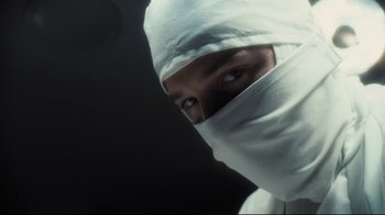 Movie still from “Orphan” (2009), directed by Jaume Collet-Serra – A man with a white cloth covering his face; Close Up shot, Low angle