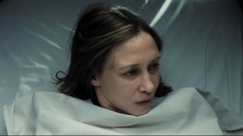 Movie still from “Orphan” (2009), directed by Jaume Collet-Serra – A woman is laying in a white sheet; Close Up shot, Overhead angle