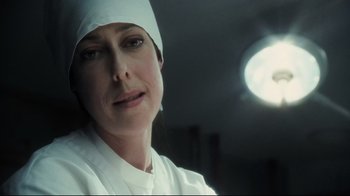 Movie still from “Orphan” (2009), directed by Jaume Collet-Serra – A woman in a white lab coat and a hat; Close Up shot, Low angle