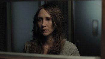 Movie still from “Orphan” (2009), directed by Jaume Collet-Serra – A woman looking into a bathroom mirror; Close Up shot, High angle