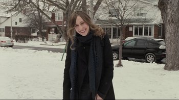 Movie still from “Orphan” (2009), directed by Jaume Collet-Serra – A woman standing in the middle of a snow covered street; Medium shot, Over the shoulder angle