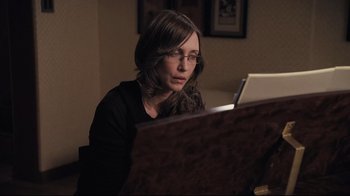 Movie still from “Orphan” (2009), directed by Jaume Collet-Serra – A woman sitting in front of a computer screen; Close Up shot, High angle
