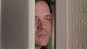 Movie still from “Orphan” (2009), directed by Jaume Collet-Serra – A person looking through a window; Close Up shot, Over the shoulder angle