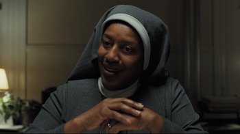 Movie still from “Orphan” (2009), directed by Jaume Collet-Serra – A woman in a nun's outfit smiling for the camera; Close Up shot, Low angle