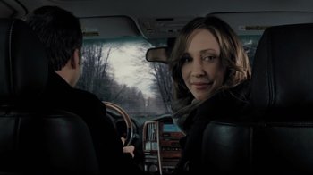 Movie still from “Orphan” (2009), directed by Jaume Collet-Serra – A woman sitting in the drivers seat of a car; Close Up shot, Over the shoulder angle