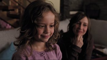 Movie still from “Orphan” (2009), directed by Jaume Collet-Serra – A little girl smiling next to a woman; Close Up shot, Over the shoulder angle