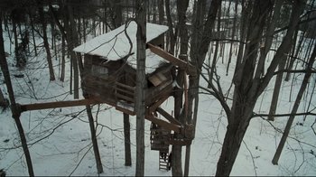 Movie still from “Orphan” (2009), directed by Jaume Collet-Serra – A tree house in the middle of a snowy forest; Extreme Wide shot, Overhead angle