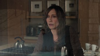 Movie still from “Orphan” (2009), directed by Jaume Collet-Serra – A woman sitting at a table in front of a window; Close Up shot, Over the shoulder angle