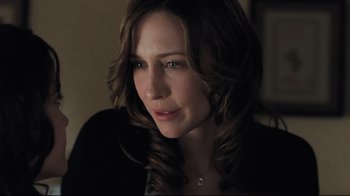 Movie still from “Orphan” (2009), directed by Jaume Collet-Serra – A person with long hair; Close Up shot, Over the shoulder angle