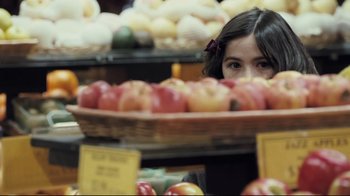 Movie still from “Orphan” (2009), directed by Jaume Collet-Serra – A woman looking over a basket of apples in a grocery store; Close Up shot, Over the shoulder angle