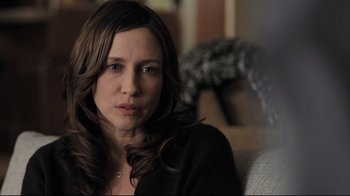 Movie still from “Orphan” (2009), directed by Jaume Collet-Serra – A person sitting on a couch; Close Up shot, Over the shoulder angle