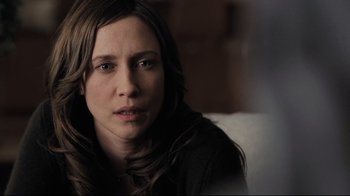 Movie still from “Orphan” (2009), directed by Jaume Collet-Serra – A person sitting on a couch; Close Up shot, Over the shoulder angle