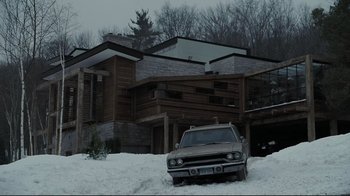 Movie still from “Orphan” (2009), directed by Jaume Collet-Serra – A car parked in the snow in front of a house; Extreme Wide shot, Low angle