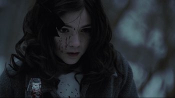 Movie still from “Orphan” (2009), directed by Jaume Collet-Serra – A young girl with blood on her face; Close Up shot, High angle