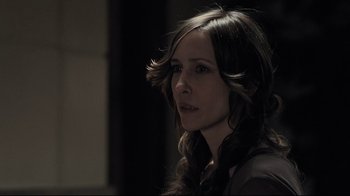 Movie still from “Orphan” (2009), directed by Jaume Collet-Serra – A beautiful woman with long brown hair looking at the camera; Close Up shot, Over the shoulder angle