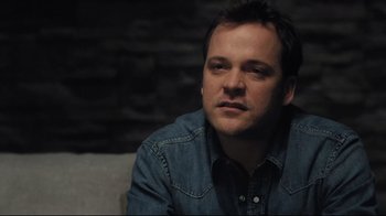 Movie still from “Orphan” (2009), directed by Jaume Collet-Serra – A person sitting on a couch; Close Up shot, Over the shoulder angle