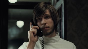 Movie still from “Orphan” (2009), directed by Jaume Collet-Serra – A man with long hair talking on a phone; Close Up shot, Over the shoulder angle
