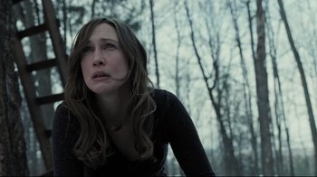 Movie still from “Orphan” (2009), directed by Jaume Collet-Serra – A woman in a black shirt looking up at the sky; Close Up shot, Low angle